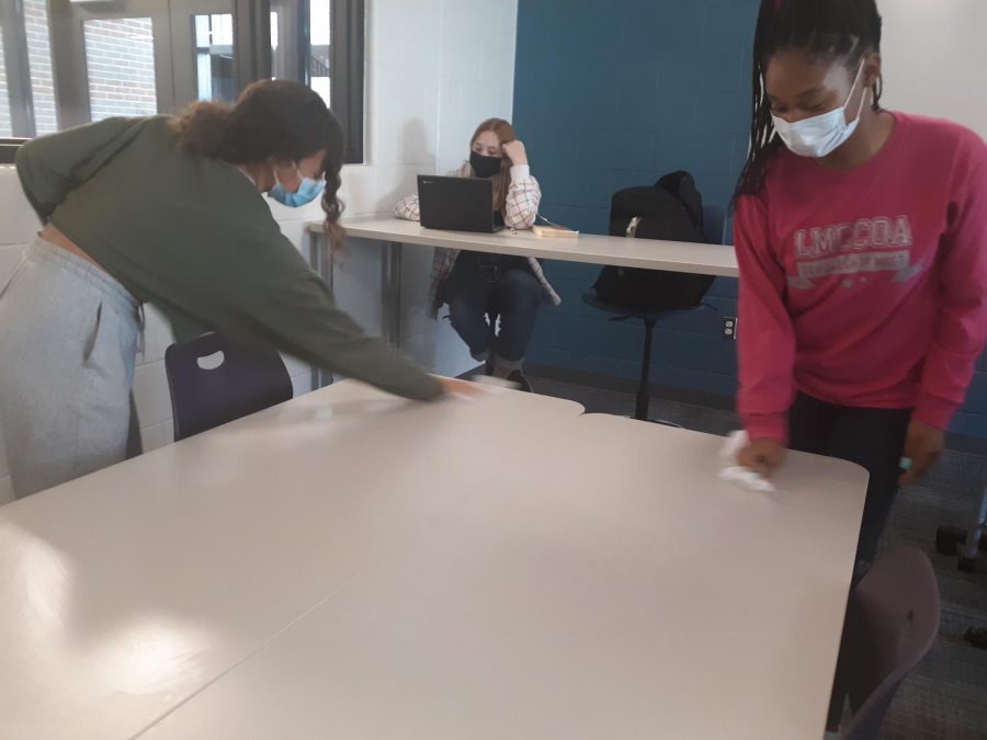 Students wiping down desks