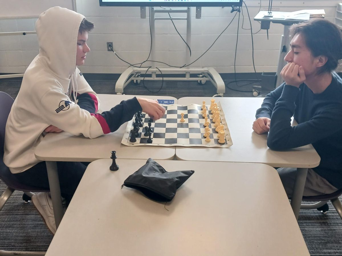 Bennett VanHarn and Brandon Choe playing chess at chess club